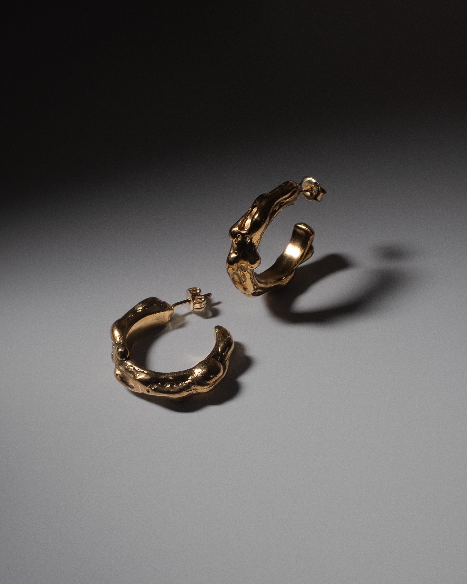 Gold abstract statement hoop earrings. Handmade and crafted in sustainable gold and silver. Unique modern jewellery London based brand.