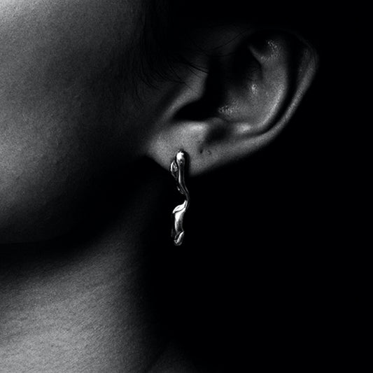 Recycled silver handcrafted dangle drop abstract molten earring. London based unique jewellery brand.